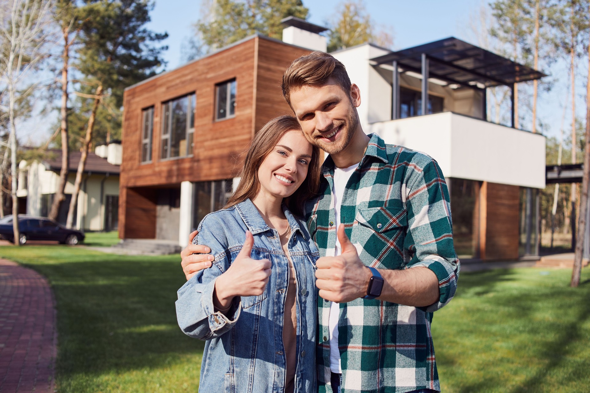 Smiling young family hugging and looking at camera