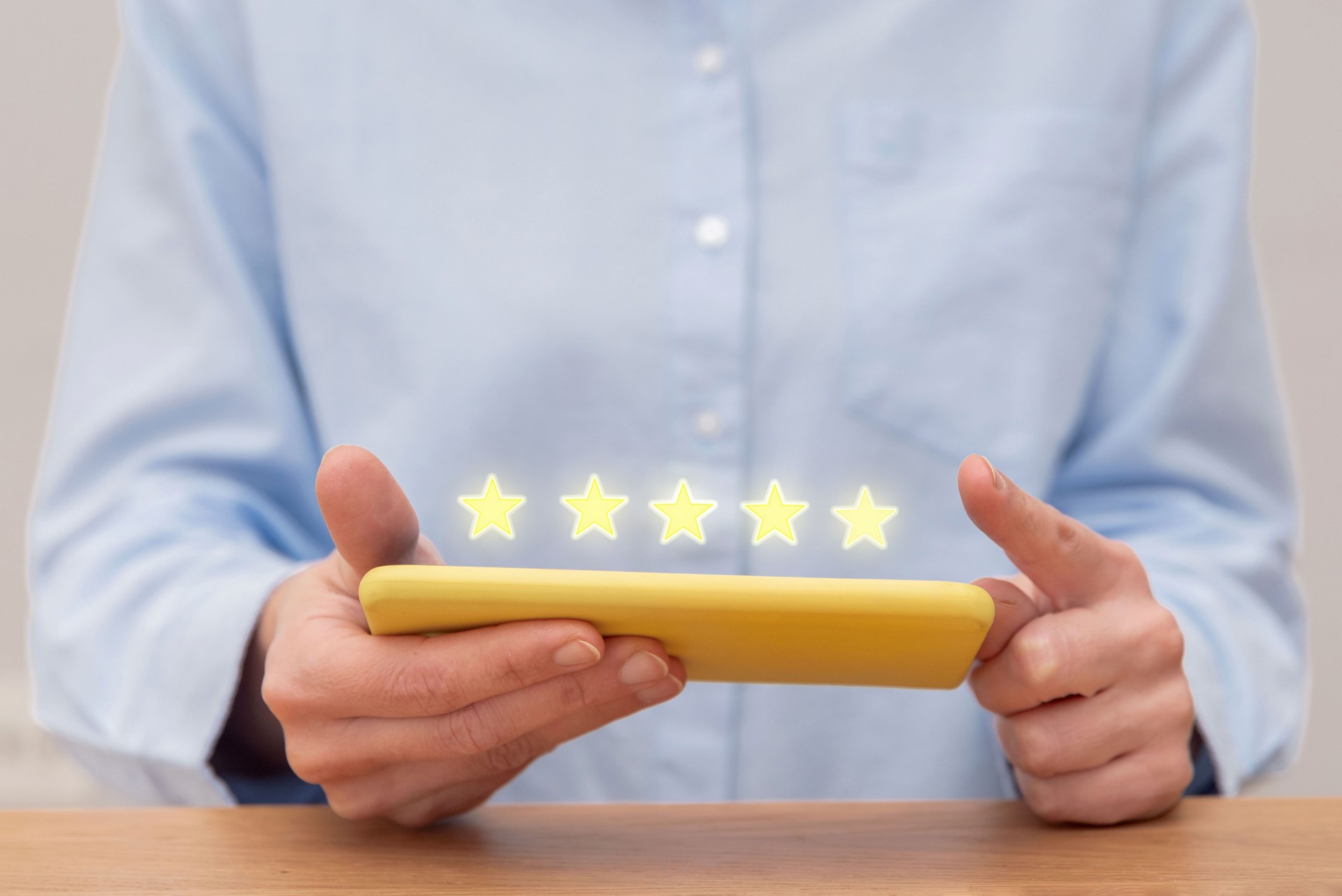 Close up of customer hands giving five star feedback on mobile phone for excellent customer service